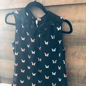 A black sleeveless shirt with a lace collar.